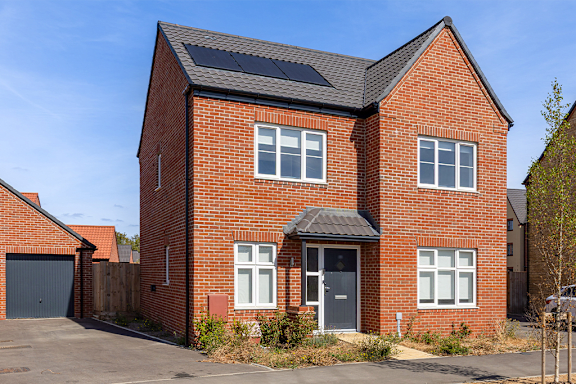 A red brick house with a black door and windows.