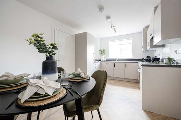A modern dining room with a table set for a meal.