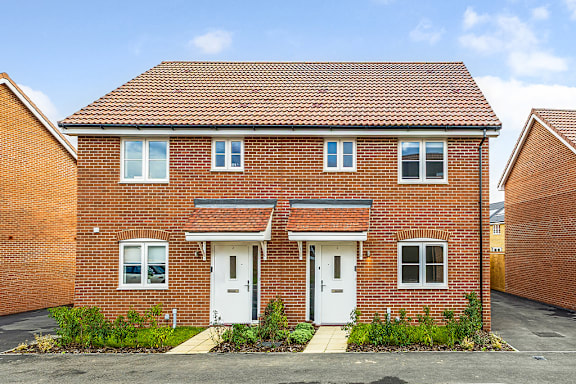 A red brick house with a white door and windows.