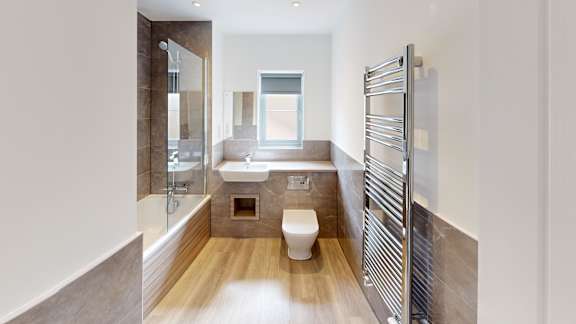 A modern bathroom with a walk-in shower and a toilet.