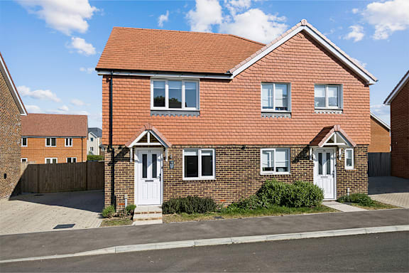 A red brick house with white doors and windows.