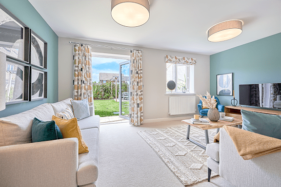 A living room with a white couch and a rug.