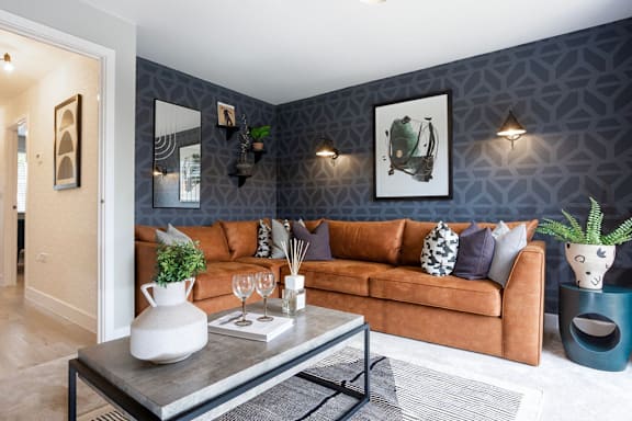 A living room with a brown couch and a coffee table.