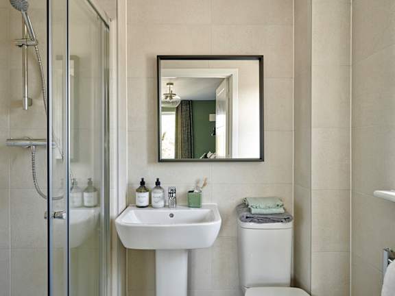 A bathroom with a white sink and a mirror above it.