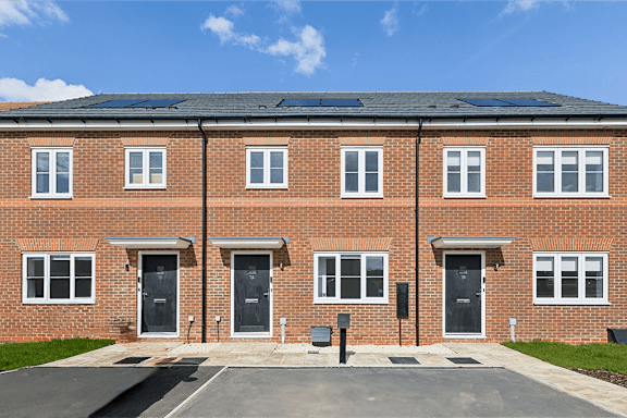 A red brick building with solar panels on the roof.
