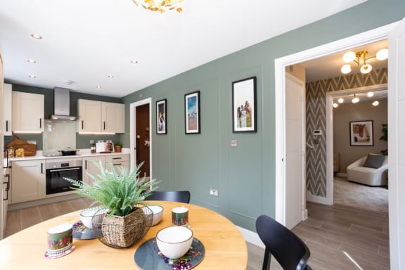 a dining room and kitchen with a table and chairs