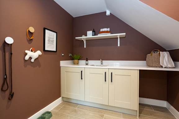 A bathroom with brown walls and a white sink.