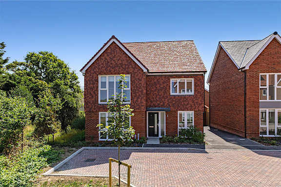 A red brick house with a white door and windows.