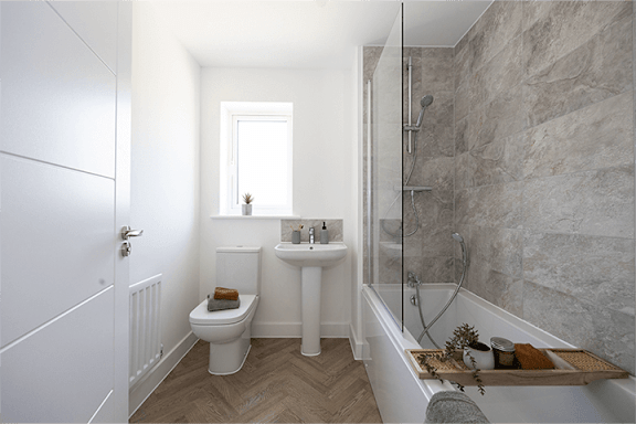 A bathroom with a toilet, sink, and bathtub.