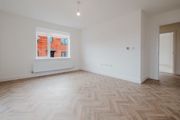 A room with a window and a radiator on the wall.