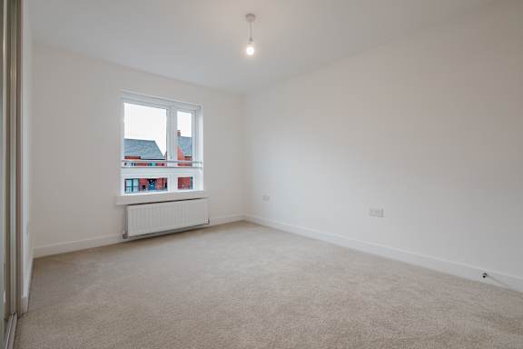 A room with a window and a radiator.