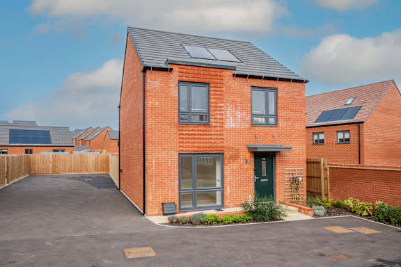 A red brick house with a black door and windows.