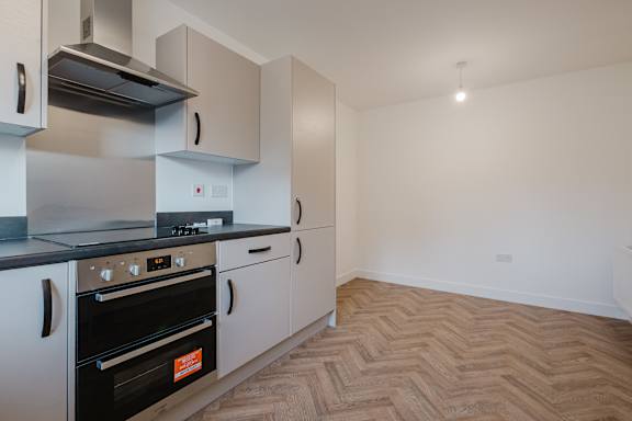 A kitchen with a stove top oven and a microwave.