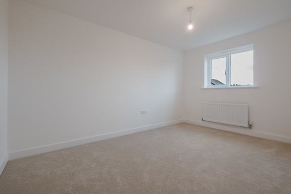 A room with a window and a radiator on the wall.