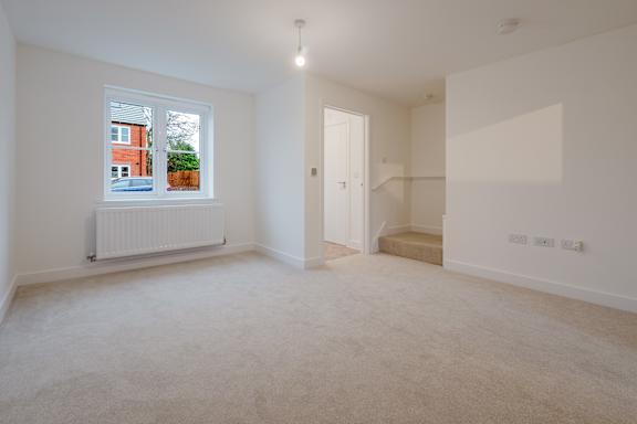 A white room with a window and a door.