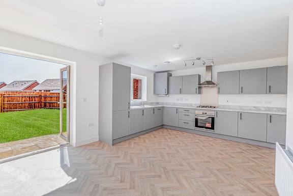 A modern kitchen with a herringbone patterned floor.