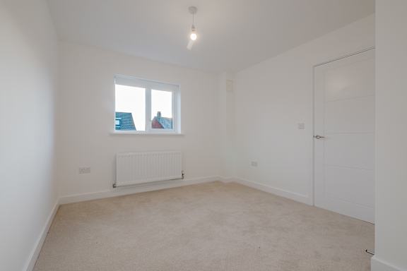 A room with a window and a radiator.