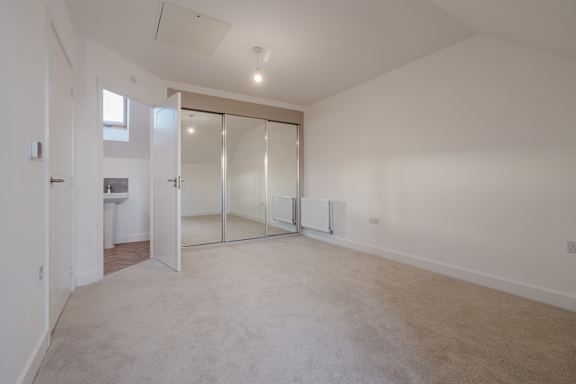A large, empty room with a sliding glass door.