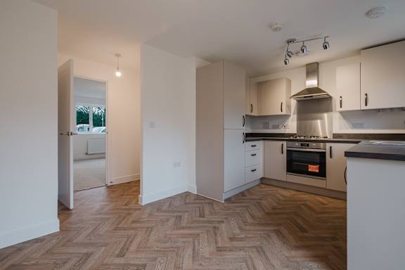 A kitchen with a stove on and a counter.