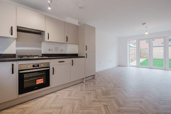 A kitchen with a stove and oven built into the cabinetry.