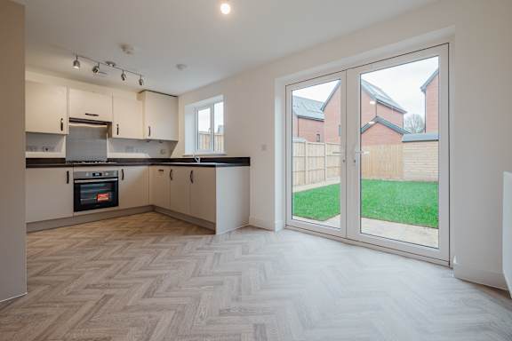 A kitchen with a herringbone patterned floor.