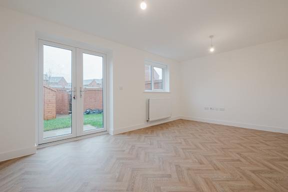 A room with a wooden floor and a window.