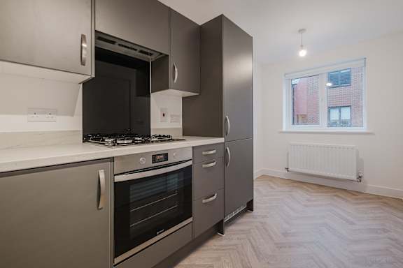 A modern kitchen with a stove, oven, and refrigerator.