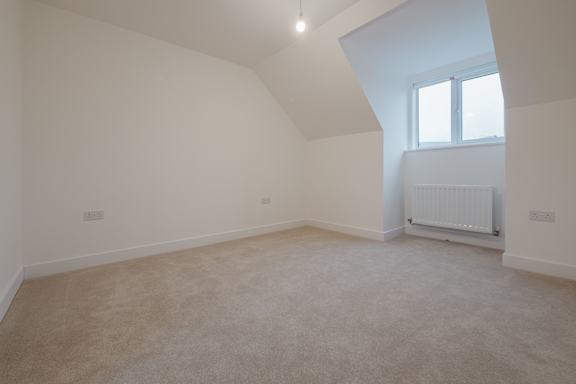 A room with a window and a radiator on the wall.