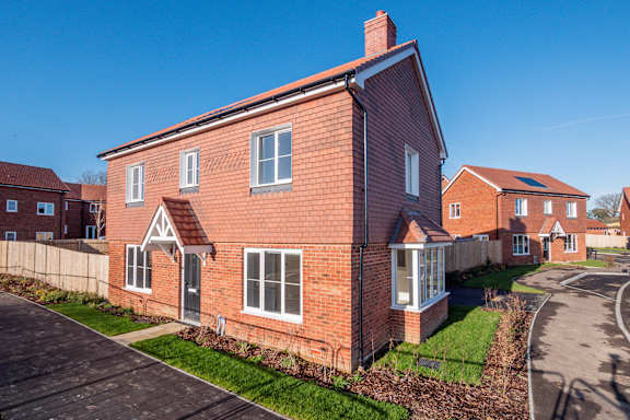 A red brick house with a clear blue sky in the background.