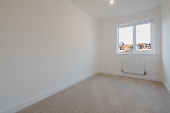 A room with a window and a radiator on the wall.