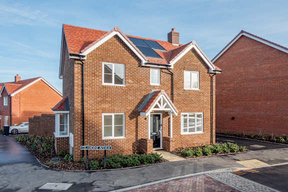 A red brick house with a black door and windows.