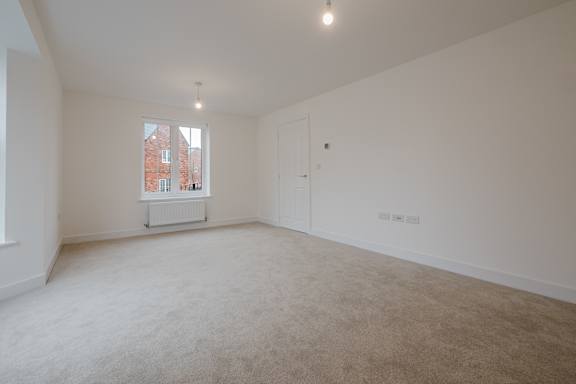 A room with white walls and a carpeted floor.