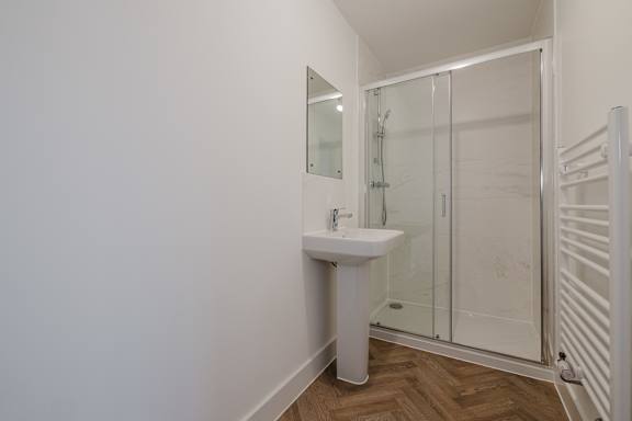A white sink in a small bathroom.