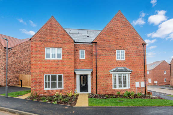 A red brick house with a black door and windows.