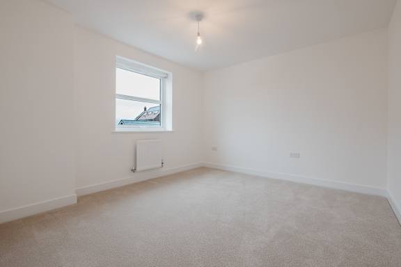 A room with a window and a radiator on the wall.