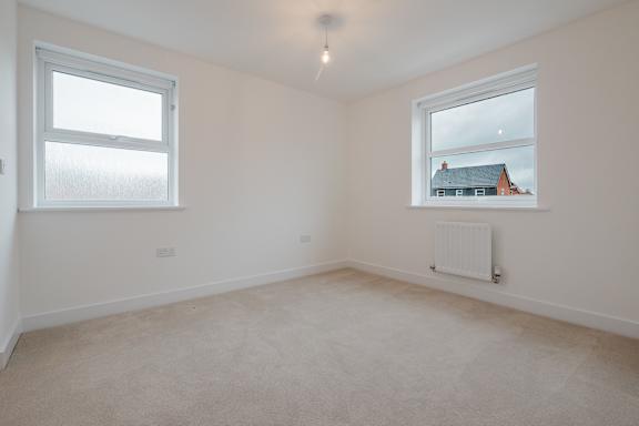 A room with a window and a radiator on the wall.