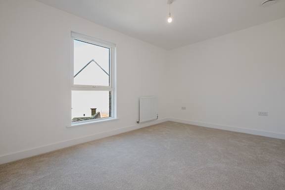 A room with a window and a radiator on the wall.