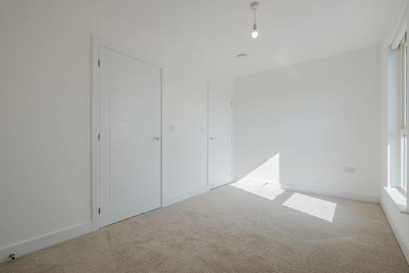 A room with two doors and a window.