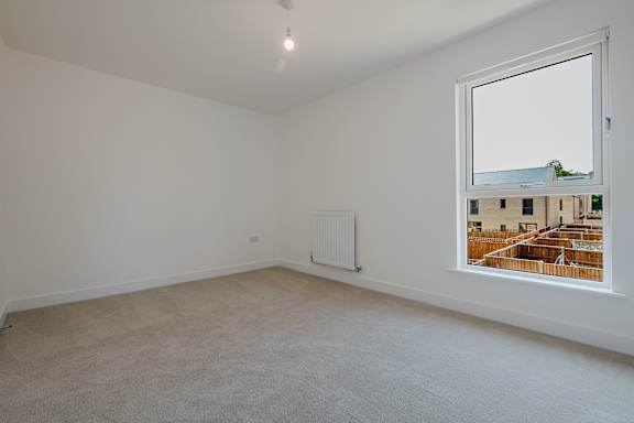 Empty room with a window showing an outdoor scene.