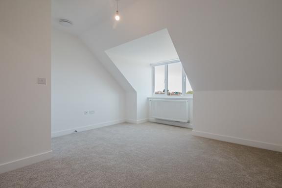 A room with a window and a radiator on the wall.