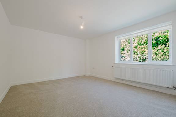 A room with a window and a radiator on the wall.