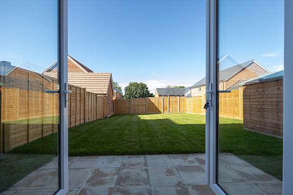 A view of a backyard through a glass door.