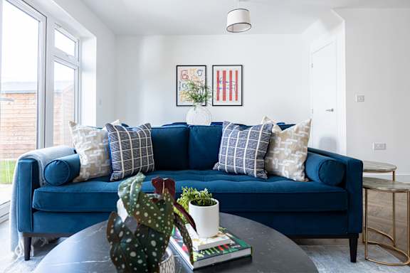 a living room with a couch and a glass table