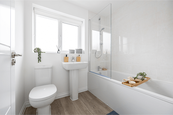 A white bathroom with a toilet, sink, and bathtub.