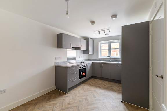 A kitchen with a stove top oven and a sink.