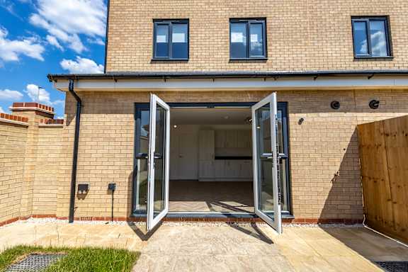 A house with a brick facade and a large open door.