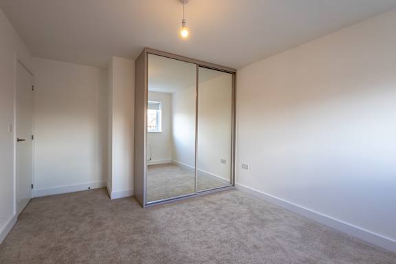 A room with a large mirror on the wall.