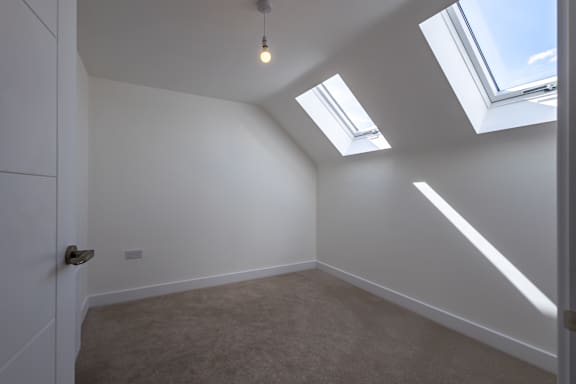 A room with a skylight and a door.