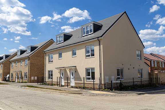 A row of houses with a clear blue sky above them.