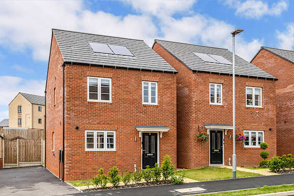 A red brick house with solar panels on the roof.